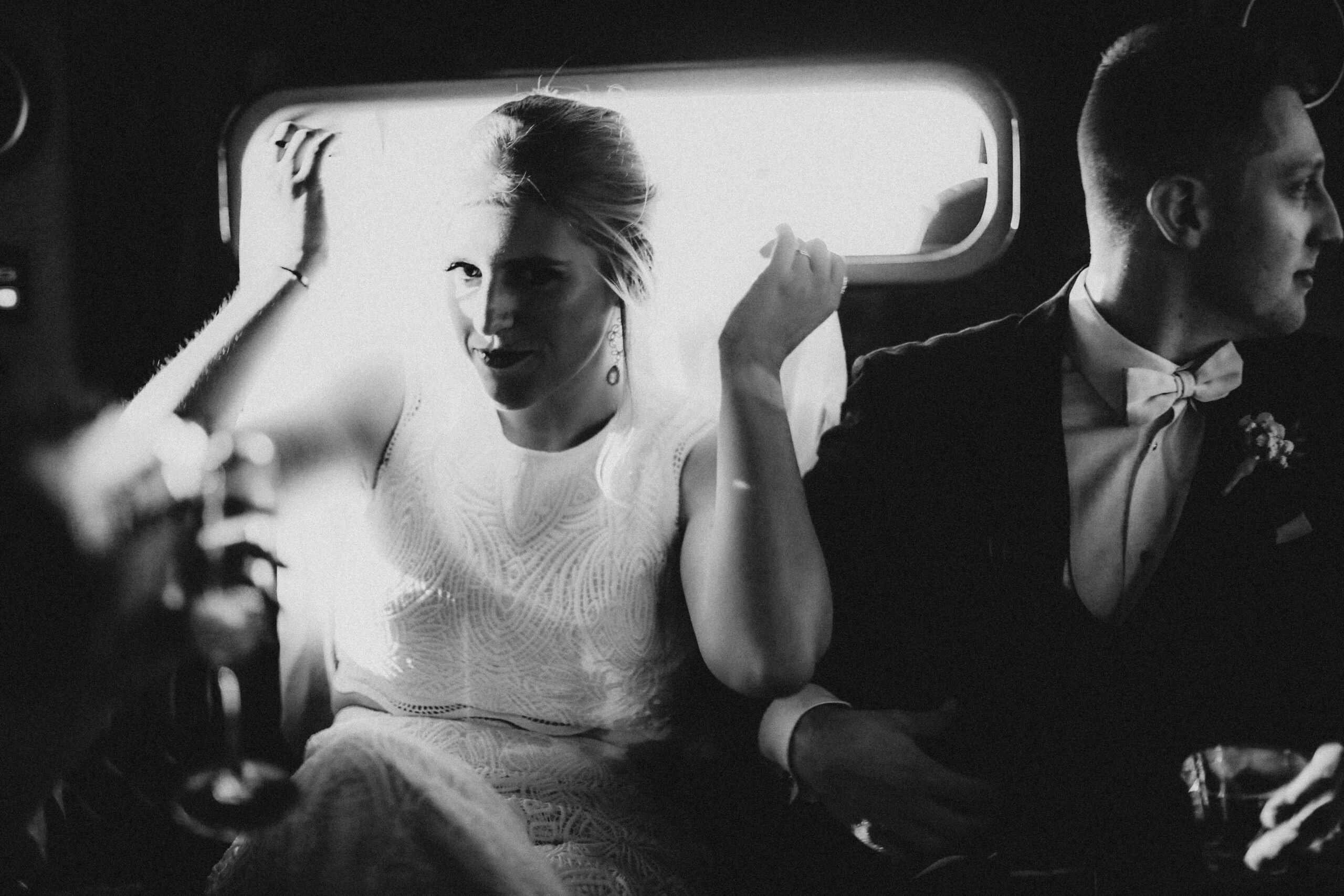 Bride and groom in rental car